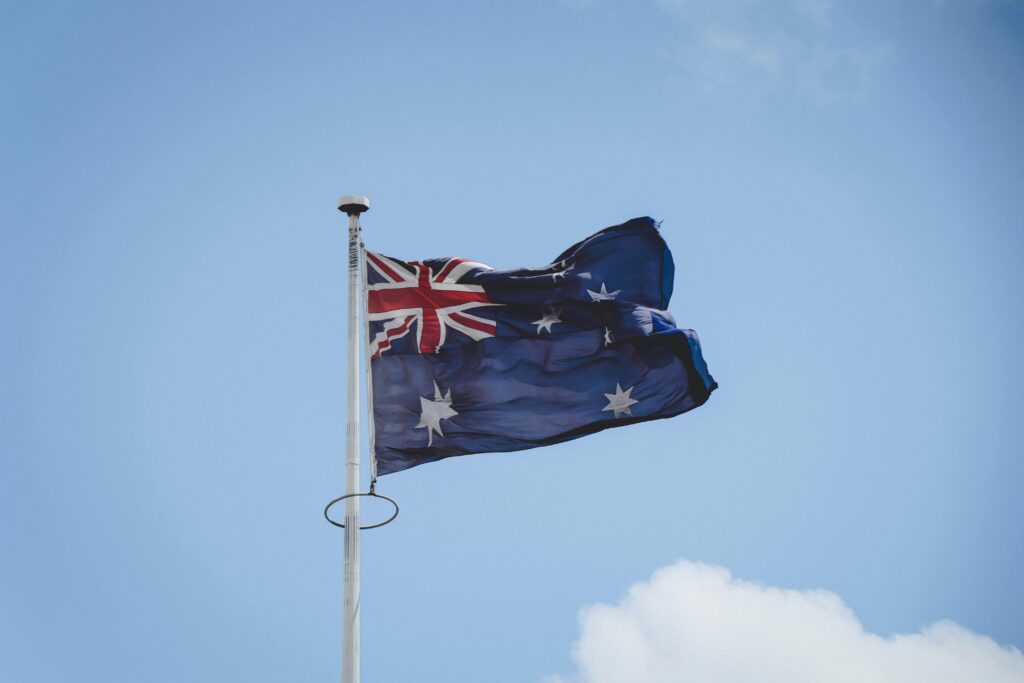 pexels-photo-1766215-1766215 Australian national flag waving on a flagpole against a clear blue sky in Perth.